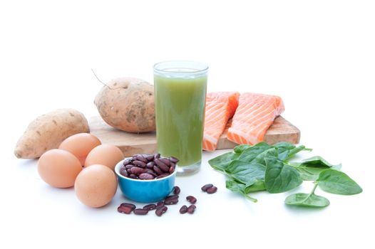 Protein ingredients including eggs, spinach leaves and pumpkin seeds with a smoothie beverage