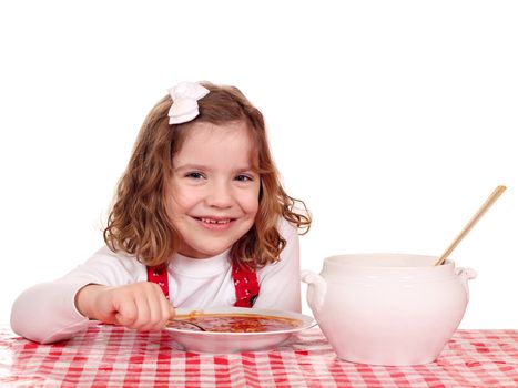 happy little girl eat tomato soup