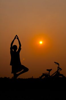 silhouette of boy Yoga with bicycle