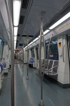 Interior of a passenger metro train with empty seats