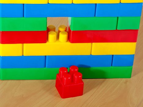 wall by stacking color plastic blocks concept
