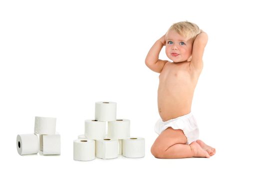 Blue eyed baby girl with hands on head with a bunch of toilet rolls. Isolated on white background.