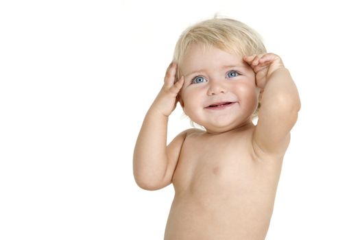 Blue eyed baby girl smiling with hands on her head. Isolated on white background.