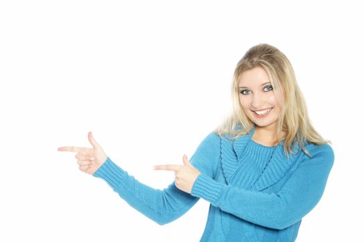 Attractive smiling young blonde woman pointing with both hands towards the left side of the frame isolated on white