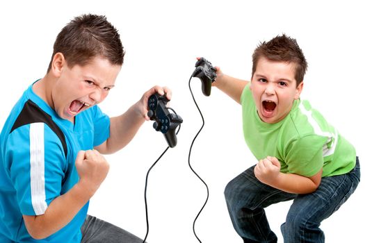 Two boys with victorious face expressions playing with video consoles. Isolated on white. 