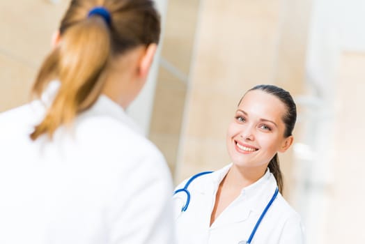 two doctors talking in the lobby of the hospital,