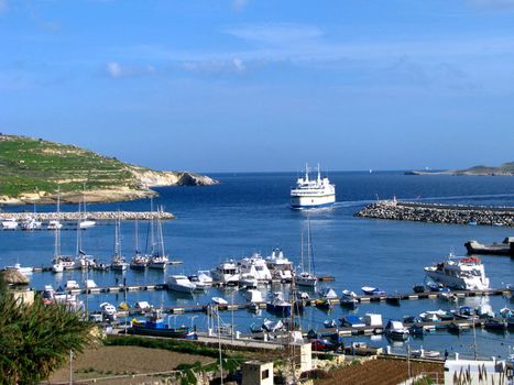 A ferry berthing into Mgarr Harbour in Gozo, Malta.