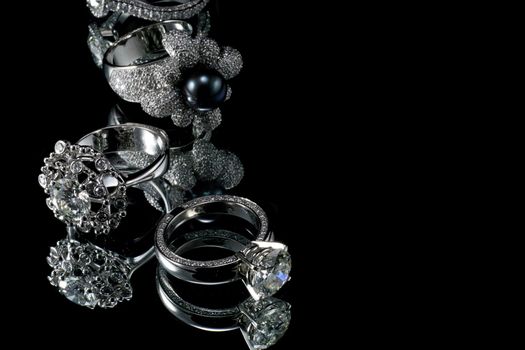 Collectionsof rings with diamond isolated on black background 