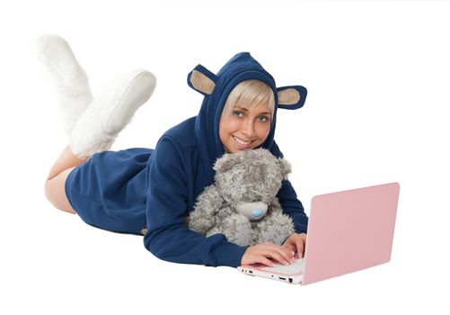 lgirl with a teddy bear on the floor with a laptop