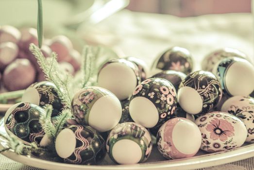 Vintage Eastern European Easter Eggs  in a plate. White eggs with floral patterns.