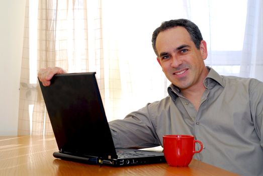 Man sitting at a desk and looking into his computer