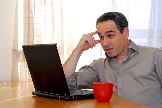 Man sitting at a desk and looking into his computer