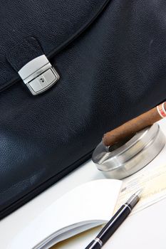 financial deal check writing cigar with black leather briefcase background praspective business concepts