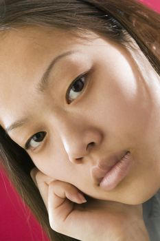 Close up view of a young Asian girl with an intense stare