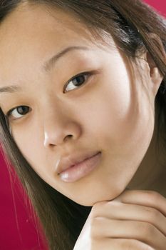 Close view of young Asian girl looking serious 
