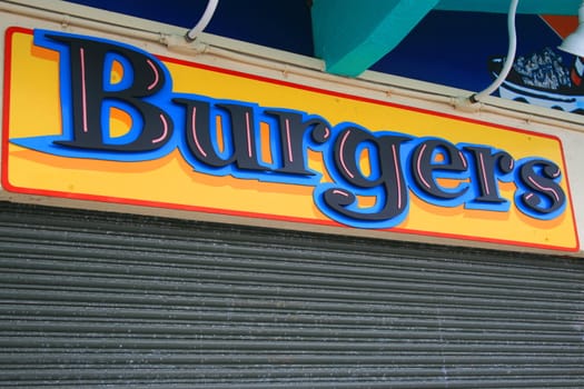 Close up of a burgers sign.

