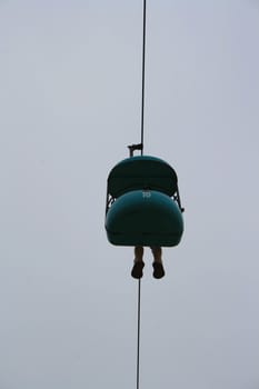 Carousel ride high over sky.