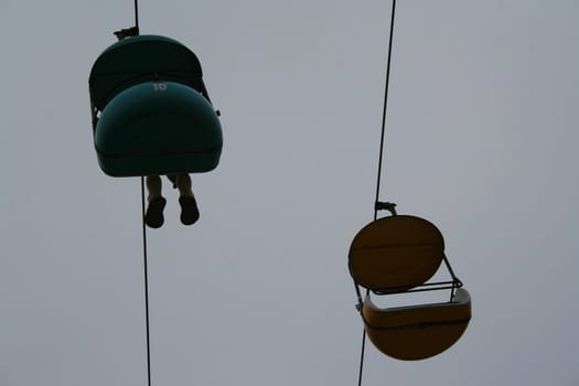 Carousel ride high over sky.