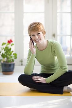 Happy young woman talking on a cell phone