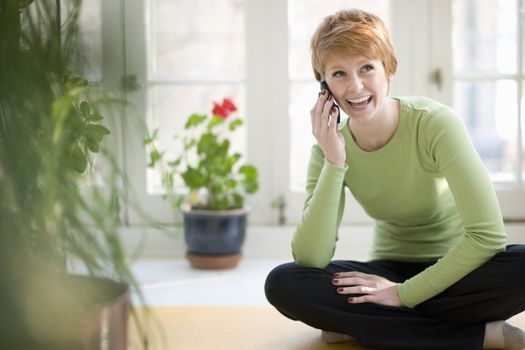Happy young woman talking on a cell phone