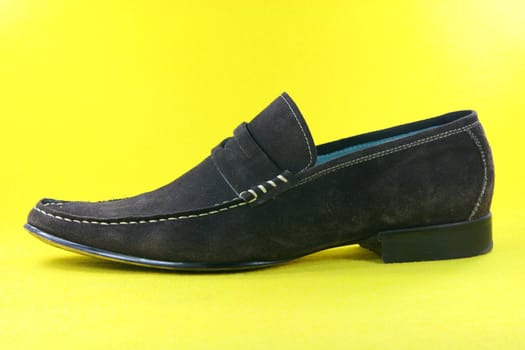 concept fashion clothing shoes in yellow background