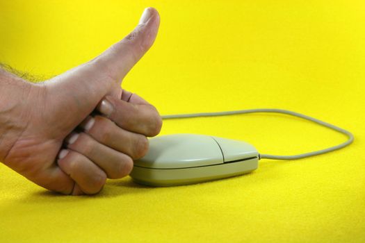 hand success with  mouse in yellow background business concepts