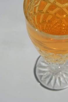 Close up of a crystal glass with a drink.
