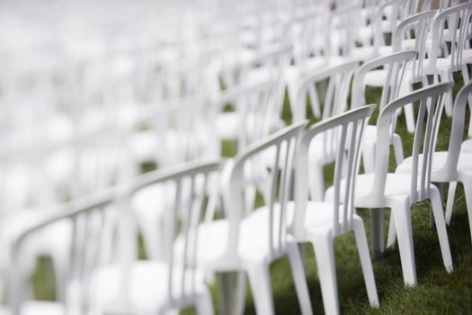 White plastic chairs set for an outdoor event