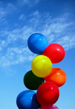 balloons in the air on against a blue sky