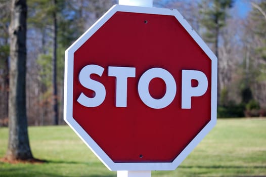 A wooden stop sign shown up close