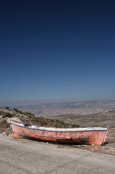 abandoned old wooden boat on the top of a mountain