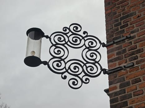 Old vintage ornate street lamp on bricks wall   