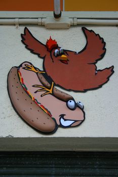 Close up of a funny hot dog sign.
