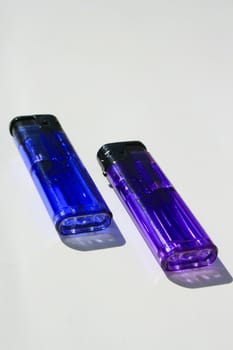 Close up of the two colorful lighters.
