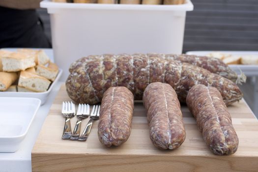 Salame and forks on cutting board