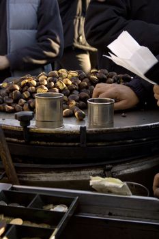 Freshly roasted chestnuts inside a iron plate