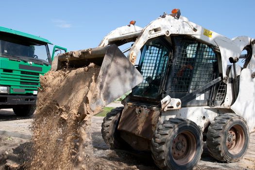 Mini Bobcat work on a street reconstruction