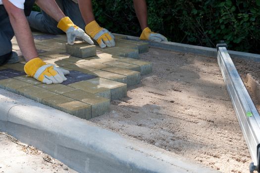 a workers made a sidewalk from bricks