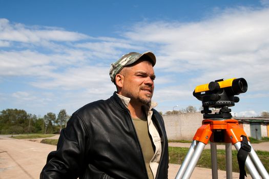Surveyor measuring land for construction