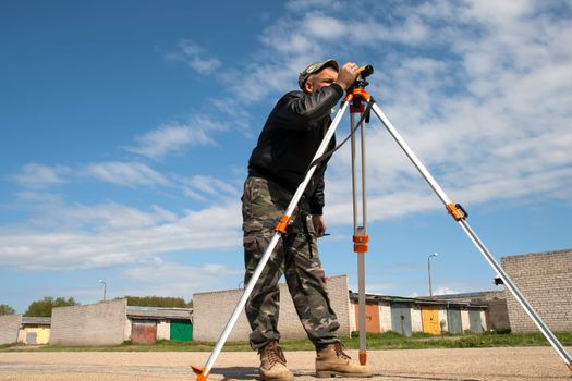 Surveyor measuring land for construction