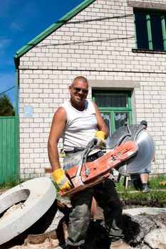 Construction worker with stone cutter in hands