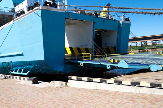 A large ferry with door open to take automobile traffic