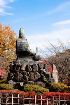 Stone monument in a Japanese autumn park 
