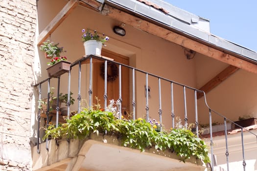 Old house with balcony with green plants in Vilnuis 
