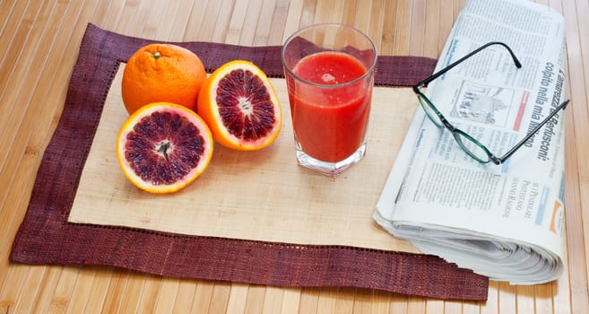 Breakfast with orange juice and newspaper