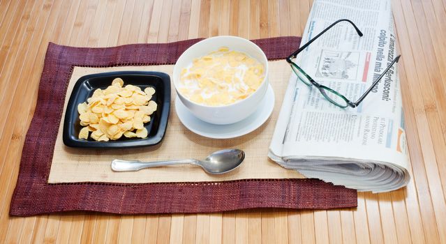 Breakfast with cereals milk and newspaper