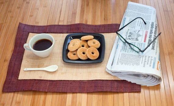Breakfast with cookies coffee and newspaper