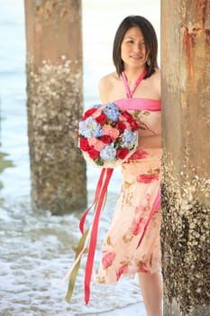 portrait of lady with beautiful bouquet on the beach