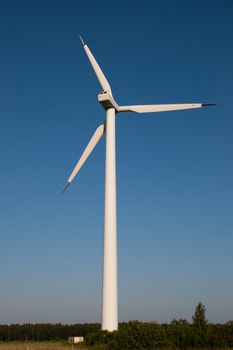 a picture of a large electric windmill against a blue sky