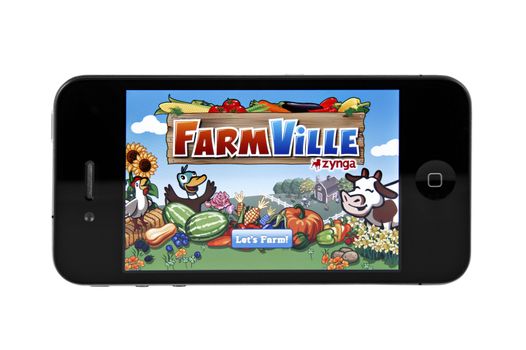 A close up studio shot of the popular game FarmVille on the iphone 4.